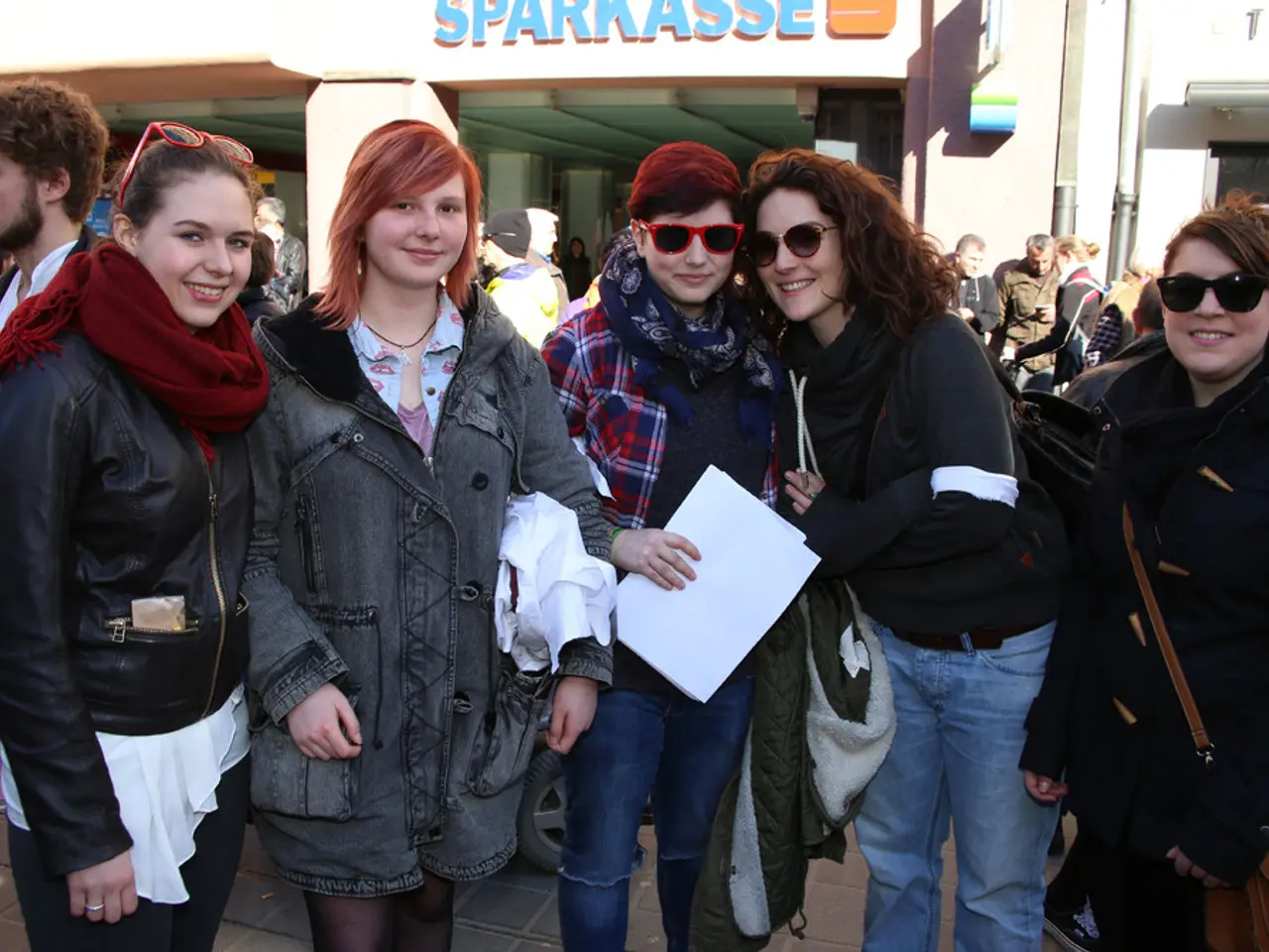 In this picture there are group of people standing and smiling and there is a woman standing and...