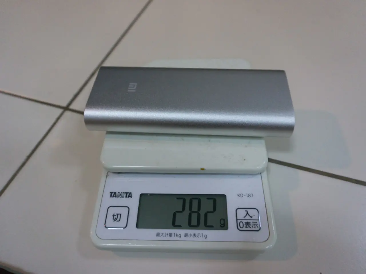 In the center of the picture there is a weighing machine and an electronic gadget. At the bottom...