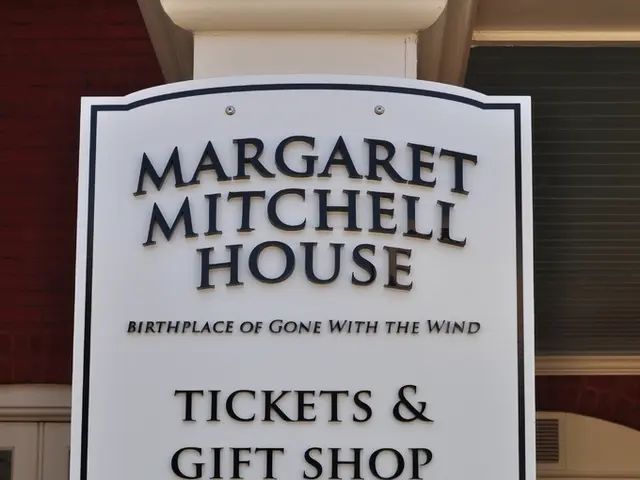 In this image we can see texts written on a board on a platform. In the background we can see...