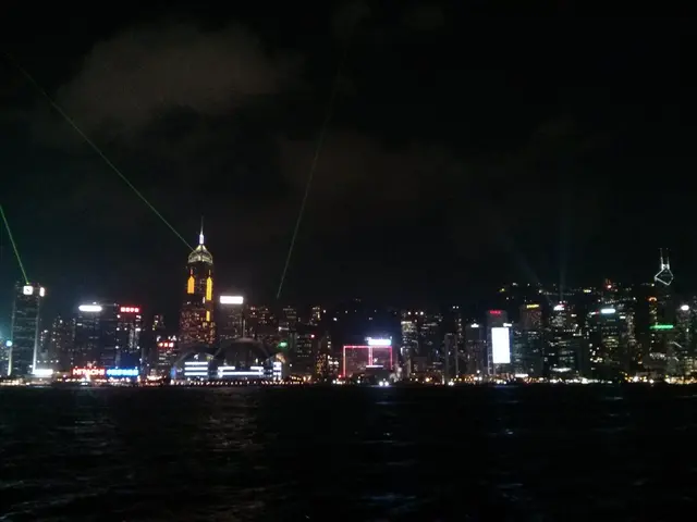 The image is captured in the night time, there is a water surface and behind that there are many...