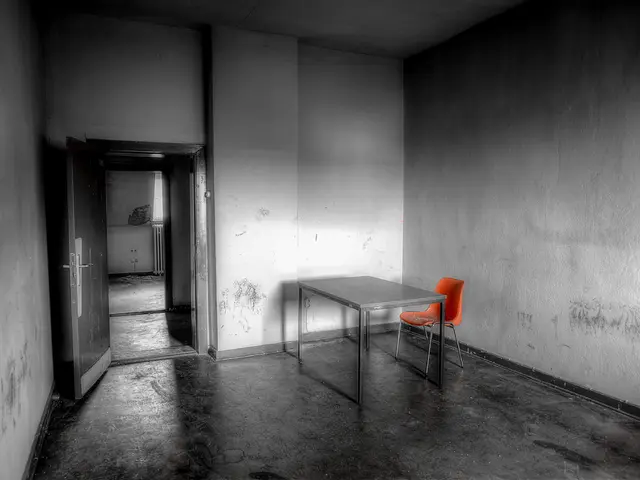 In this image we can see a table, chairs, walls, floor and also a door to access to the other...