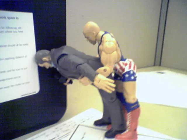 In this image there are two toys which are standing on the papers, and in the background there is a...