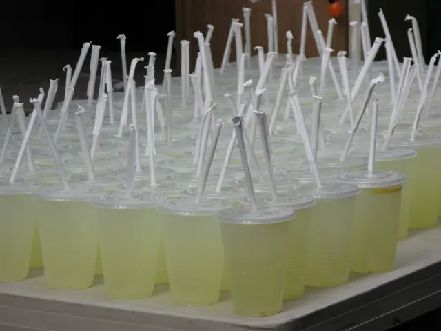 In this image we can see many drink glasses with straw on an object.