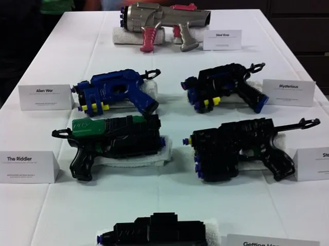 In the image on the white surface there are different types of guns. Those guns are on the white...