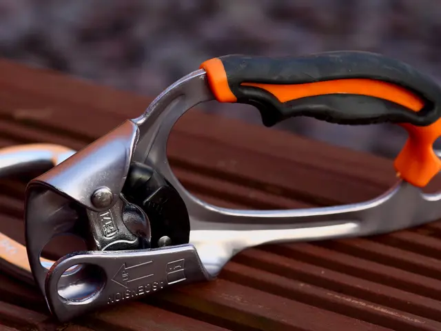 In this image, we can see a mechanical tool on the surface. Background there is a blur view.