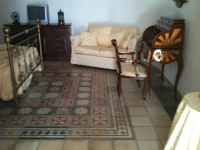 This picture describes about interior of the room, in this we can find a chair, sofa and a bed, and...