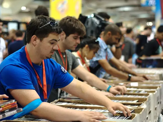 In this image there are group of people who are setting the books in the boxes with their hands....