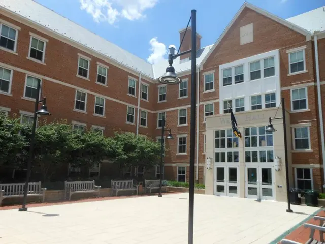 There is a big building and in front of the building there are many trees and in front of the trees...