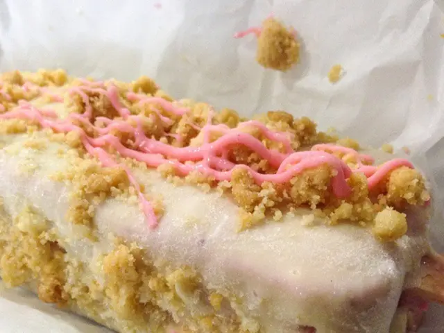 The picture consists of a food item, wrapped in a paper.