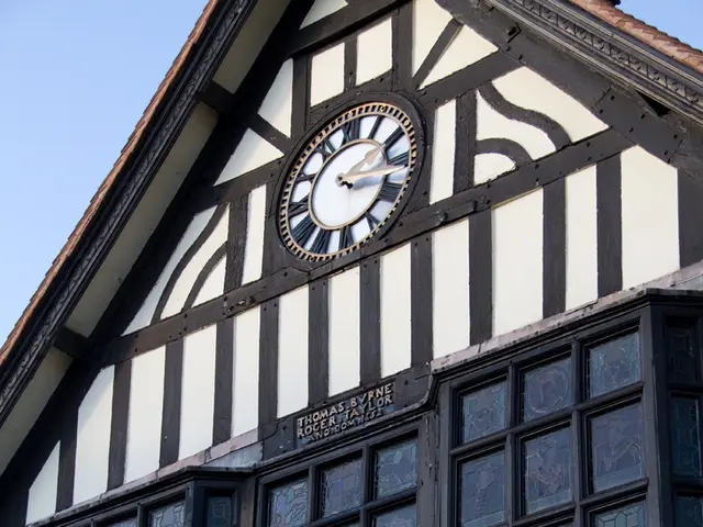 In the image I can see a building to which there is a clock, board on which there is something...