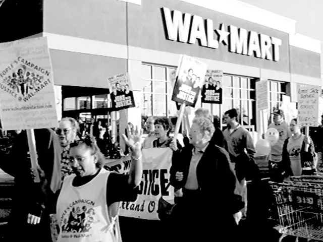 This is a black and white image, in this image there are people protesting, holding posters in...