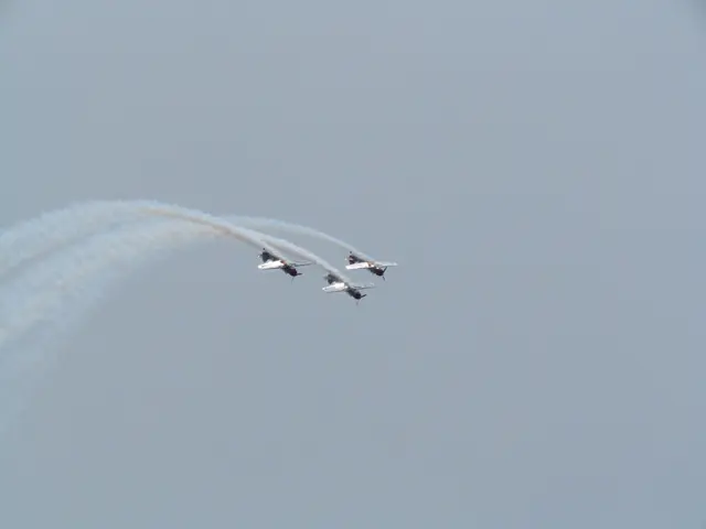 In this image there are three jets flying in the air. There is the smoke released in the air from...
